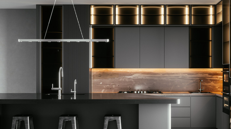 Kitchen with gray walls and cabinets and steel counter