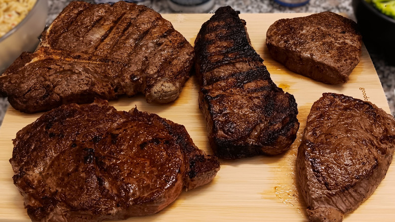 Five of LongHorn Steakhouse grilled steak cuts on cutting board