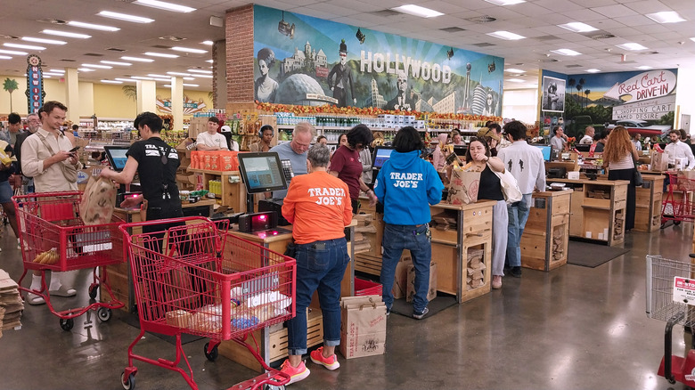 Trader Joe's members bagging groceries at checkout