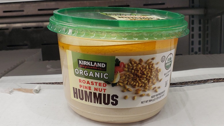 A tub of Kirkland Signature organic roasted pine nut hummus at Costco