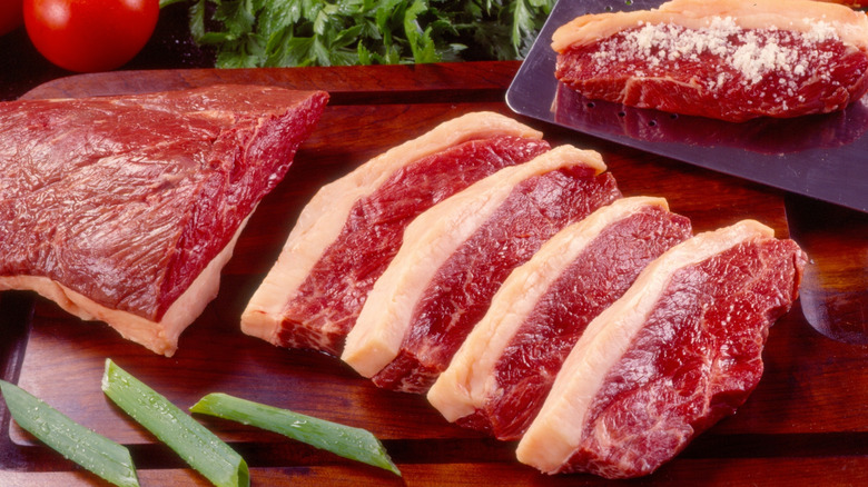 Sliced picanha steak on cutting board.