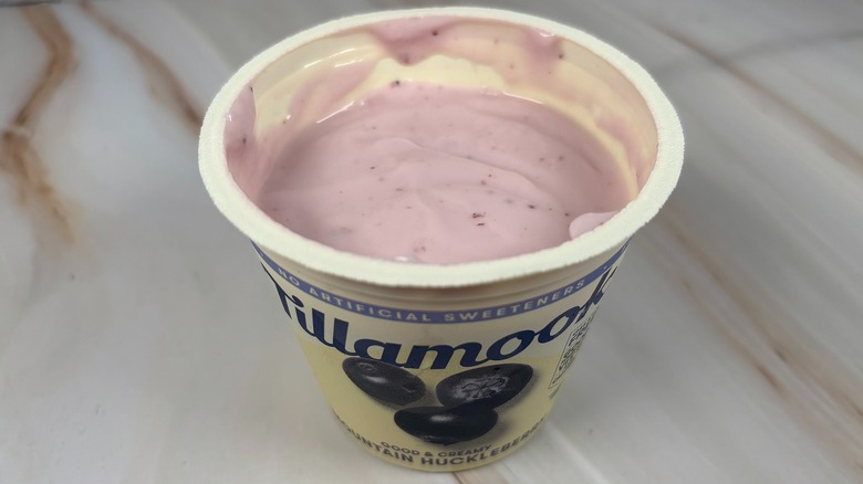Angled down shot of open container of Tillamook Mountain Huckleberry yogurt cup