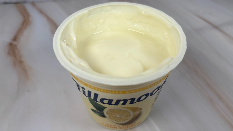 Angled down shot of open container of Tillamook Lemon Squeeze yogurt cup
