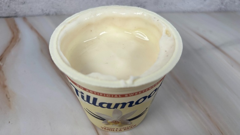 Angled down shot of open container of Tillamook Vanilla Bean yogurt cup