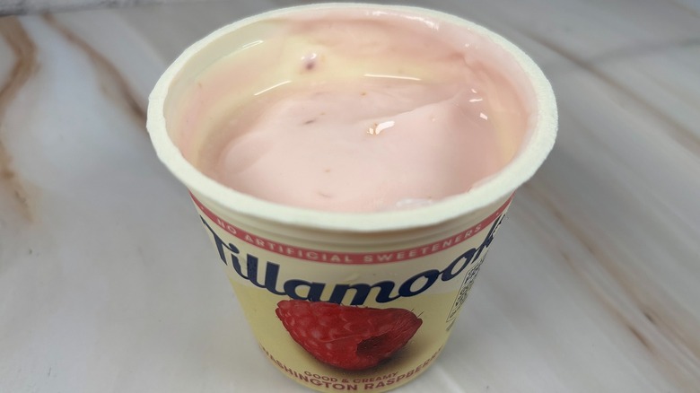 Angled down shot of open container of Tillamook Washington Raspberry yogurt cup