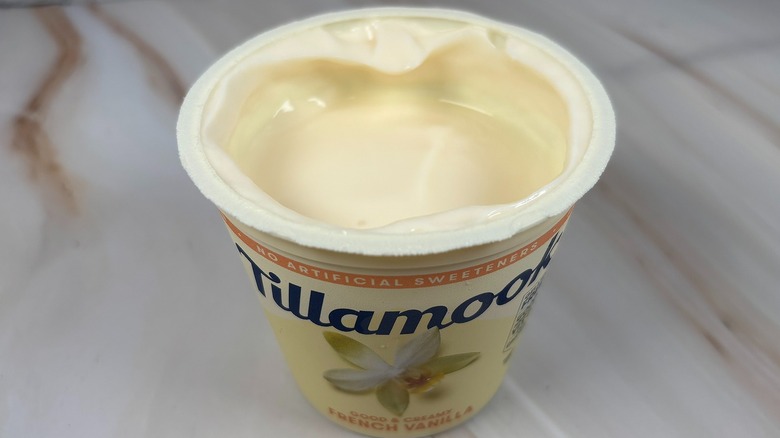 Angled down shot of open container of Tillamook French Vanilla yogurt cup