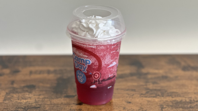 Plastic cup of Tim Hortons Strawberry Frozen Lemonade on wooden table
