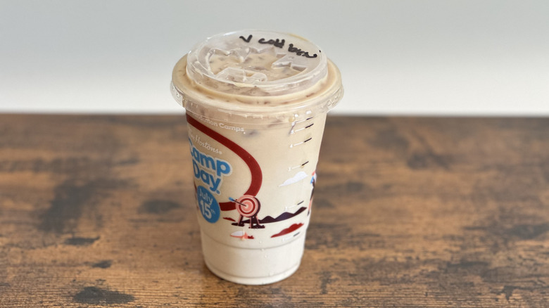 Plastic cup of Tim Hortons Vanilla Cold Brew on wooden table