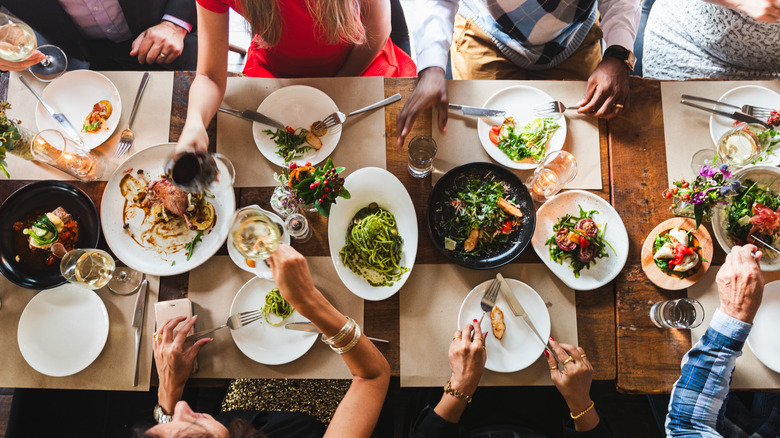 Top view of diverse group dining together and enjoying a meal.