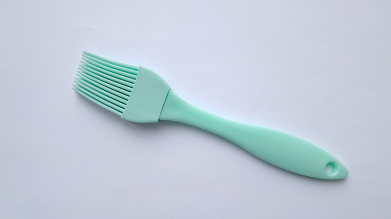 Silicone cooking brush on grey background