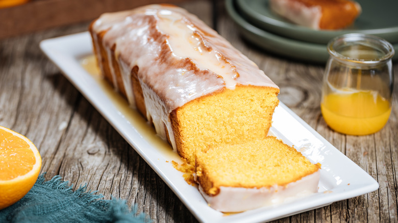 A loaf of orange pound cake with a thick glaze on top