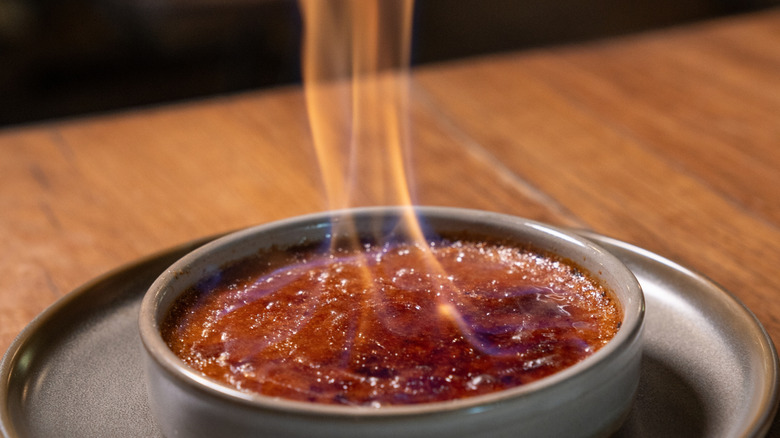 A creme brulée that's lit up in flames