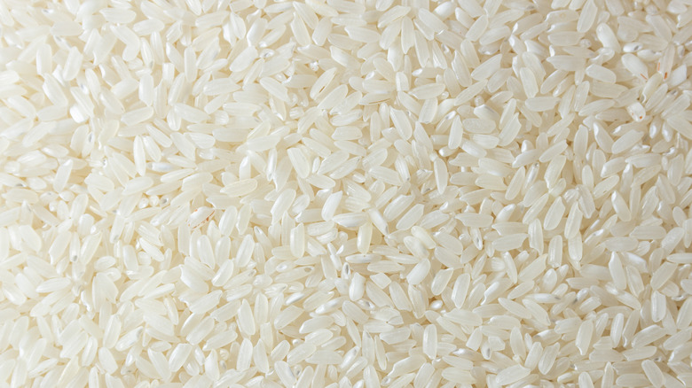 Dry uncooked rice in heap