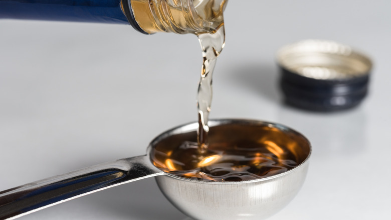 Pouring sherry into measuring spoon