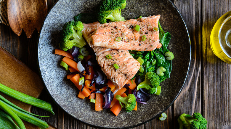 Fish and vegetable dish served on a wooden table