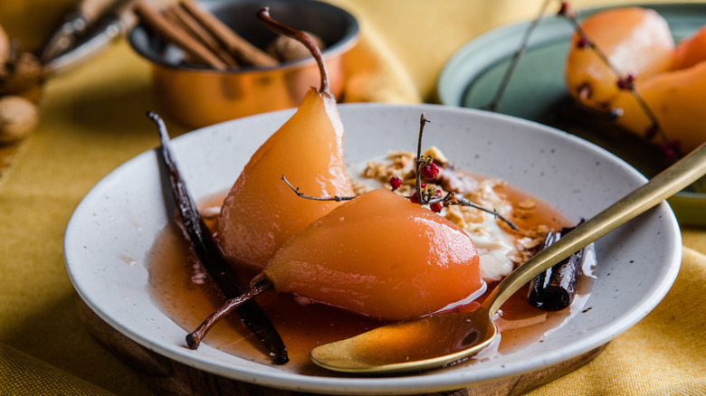 Poached pears on grey dish
