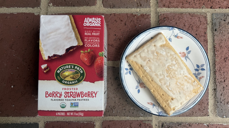 Box of Nature's Path berry strawberry toaster pastries next to unwrapped, lightly glazed pastry on plate