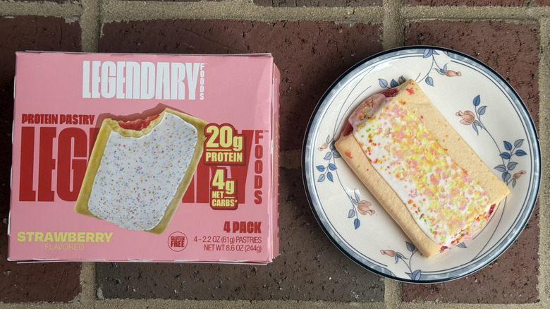 Box of Legendary Foods protein pastries next to unwrapped pastry with melted sprinkles on plate