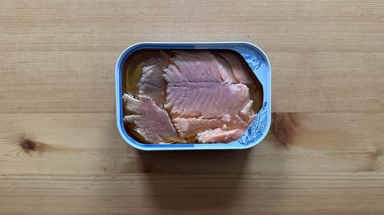 Can of Trader Joe's Farm Raised Hardwood Smoked Trout Fillets on wooden table