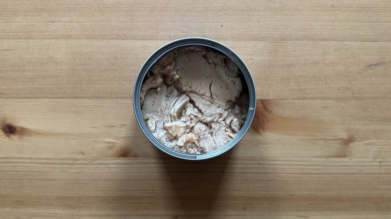 Can of Trader Joe's Solid Light Yellowfin Tuna in Olive Oil on wooden table