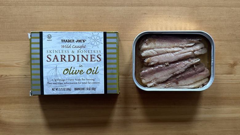 Can of Trader Joe's Wild Caught Skinless and Boneless Sardines in Olive Oil on wooden table