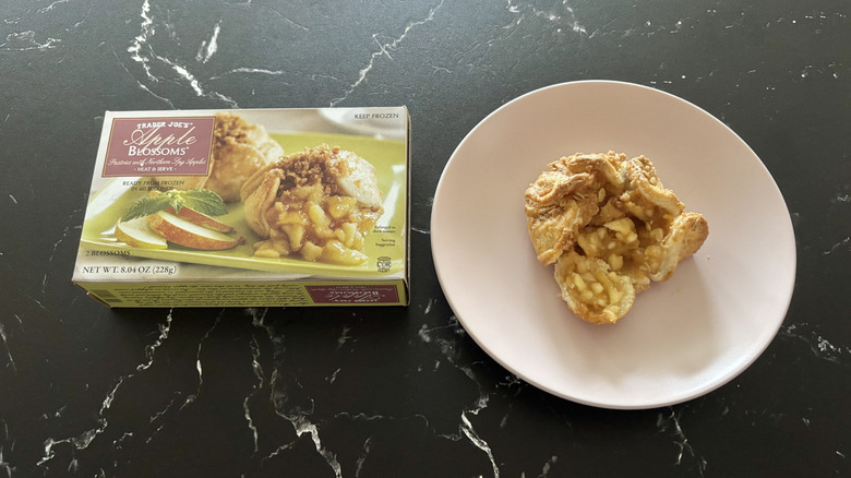 Trader Joe's apple blossoms box next to apple blossom on plate