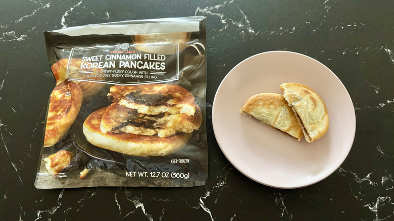 Trader Joe's sweet cinnamon Korean pancakes package next to halved pancake on plate