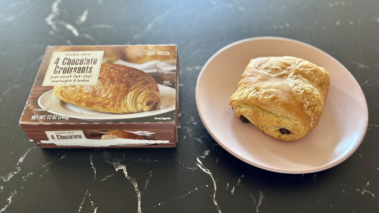 Trader Joe's chocolate croissants box next to chocolate croissant on plate
