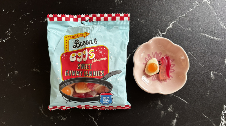 Trader Joe's bacon and egg shaped gummy candy bag next to gummies in small bowl