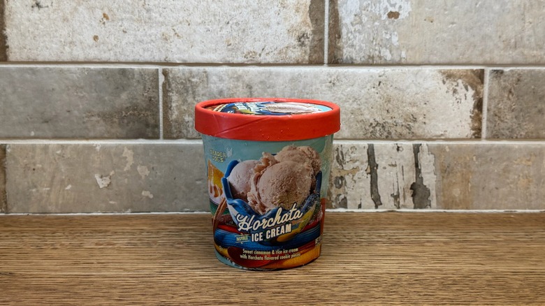 Trader Joe's Horchata ice cream in a tub with a lid on a wooden counter