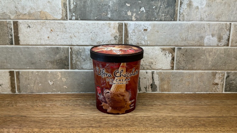 Trader Joe's Ultra Chocolate ice cream in a tub on a wooden counter