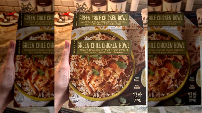 Hand holding package of Trader Joe's Green Chile Chicken Bowl