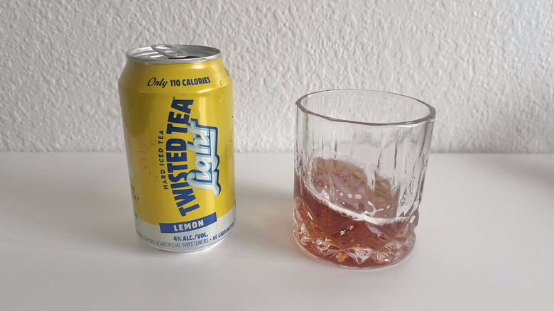 Open can of Light Lemon Twisted Tea next to a glass