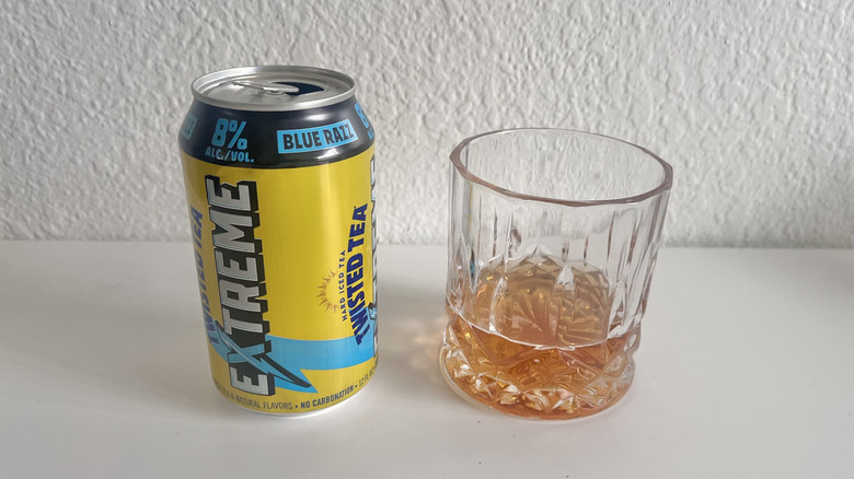 Extreme Blue Razz Twisted Tea can next to a glass