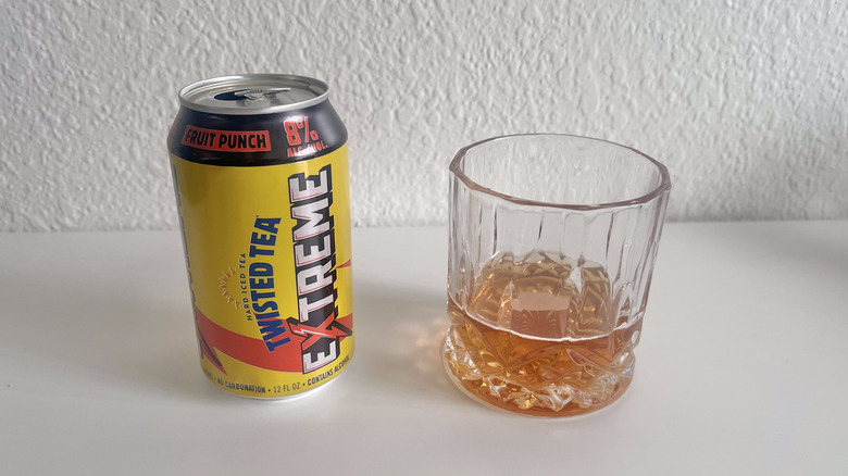 Extreme Fruit Punch Twisted Tea can next to a glass