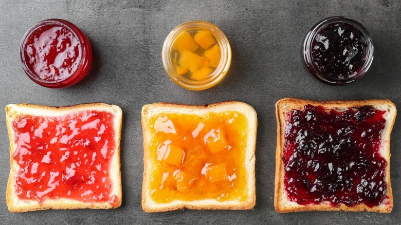 Different fruit preserves on toast