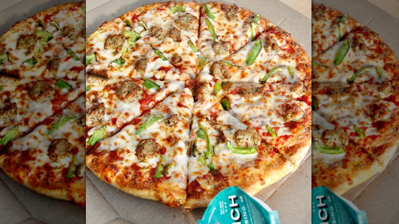 Domino's pizza with side of ranch sauce