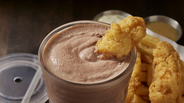 Crispy chicken finger dipped into a chocolate milkshake