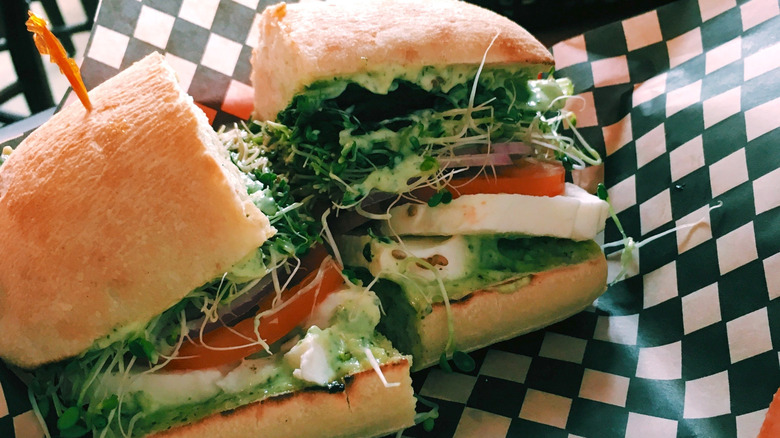 Vegetable and mozzarella sandwich on black and white checkered paper