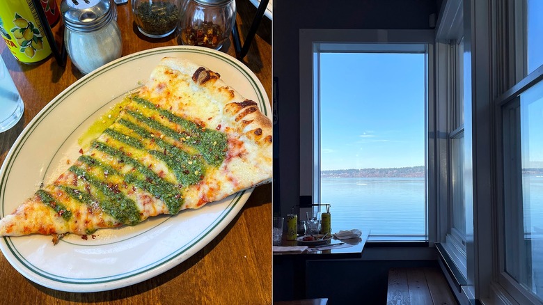 Slice of pesto pizza on a white plate with windows facing the sea on the right