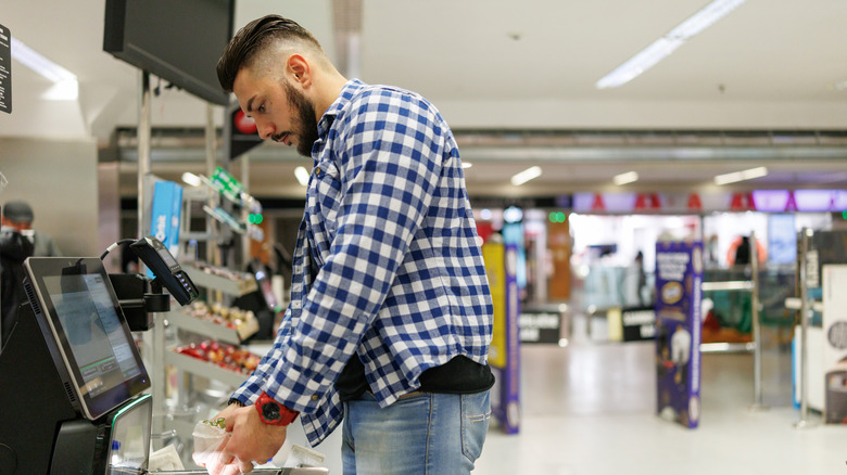 Person scanning garlic at self-checkout