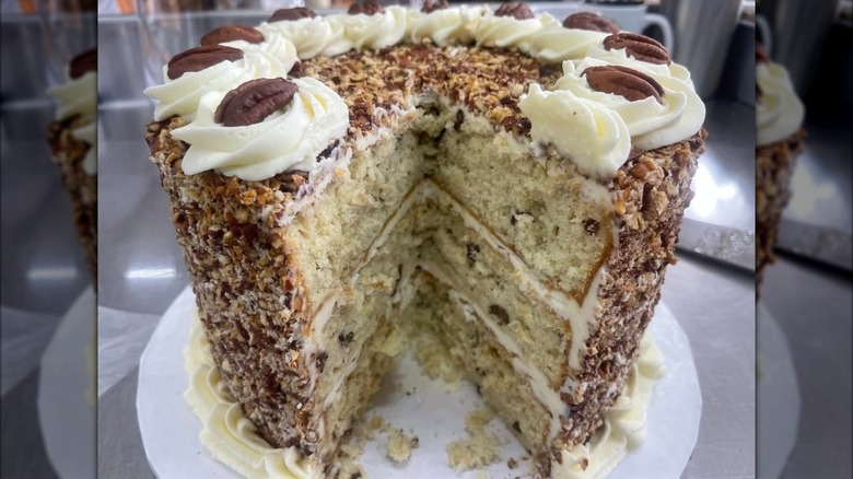 Side view of Italian cream cake with large slice removed