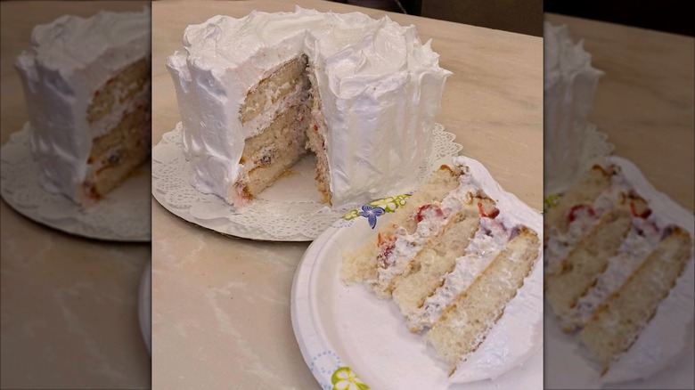 Lady Baltimore cake with slice taken out of it on plate
