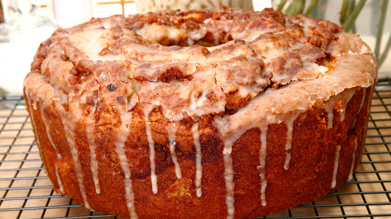 Sock It To Me Cake on cooling rack with glaze dripping down sides