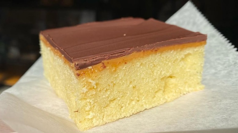 Slice of tandy cake on parchment paper