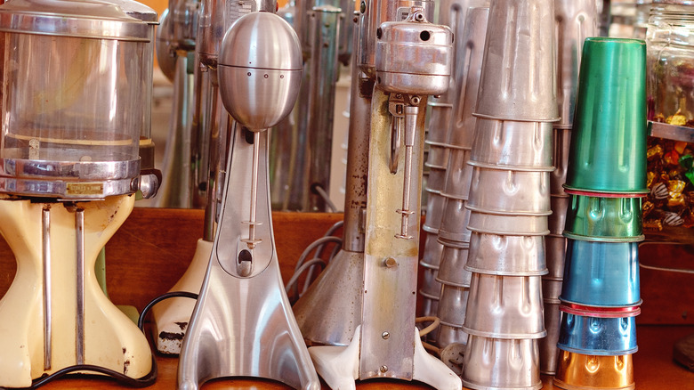 vintage milkshake makers and accessories on a shelf
