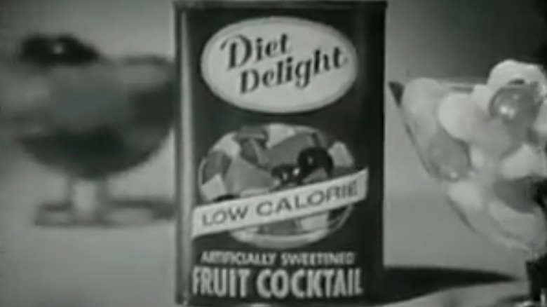 A still from a vintage black-and-white ad featuring a can of Diet Delight fruit cocktail