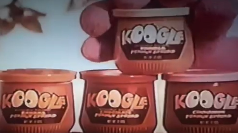 A still from a vintage ad featuring four jars of Koogle in different flavors