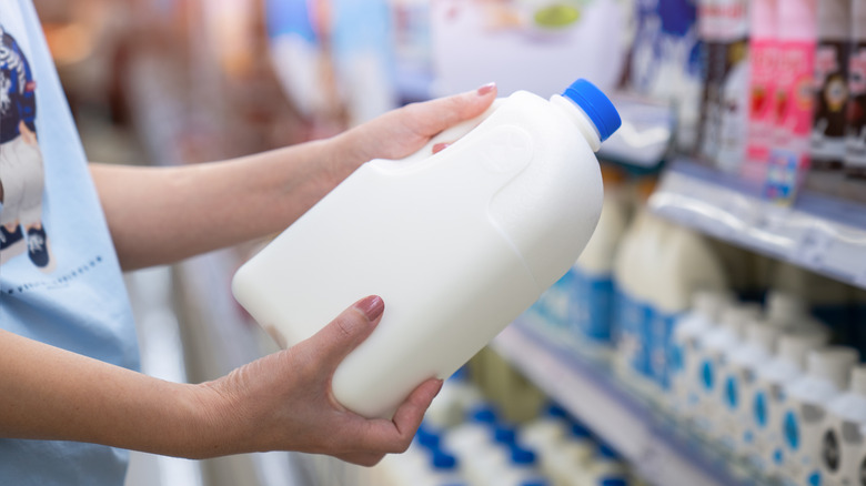 Women choosing milk at a supermarket