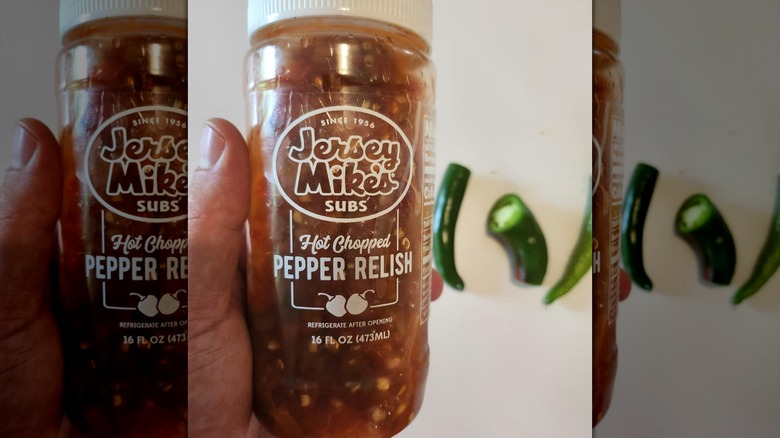 Hand holding container of Jersey Mike's Hot Chopped Pepper Relish